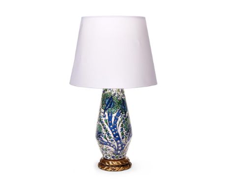 AN ISLAMIC STYLE POTTERY AND GILT METAL LAMP   MODERN  On giltwood base, with white card shade  87cm high overall including c