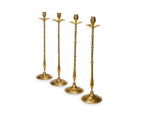 TWO PAIRS OF ARTS AND CRAFTS BRONZE CANDLESTICKS  CIRCA 1890  Of similar simulated bamboo form, pair with ring turning to noz