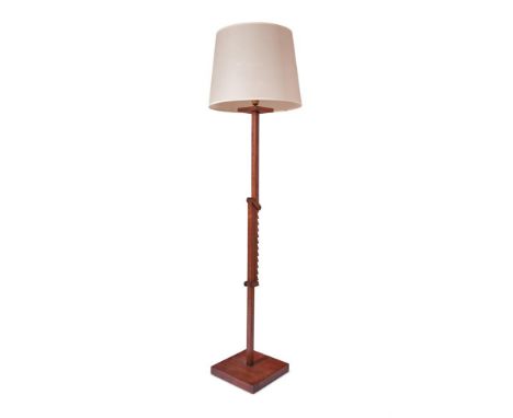 A WALNUT AND OAK ADJUSTABLE FLOOR LAMP  FRENCH, MID 20TH CENTURY  With ratchetted mid-section and cream shade  207cm high ove