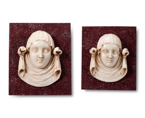 A PAIR OF ITALIAN STATUARY MARBLE FEMALE MASK PANELS  PROBABLY FLORENCE, 17TH/18TH CENTURY  Now mounted on modern faux porphy