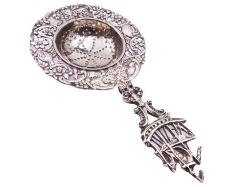 Early 20th century silver tea strainer, the circular pierced bowl with embossed and pierced surround depicting birds, huts an