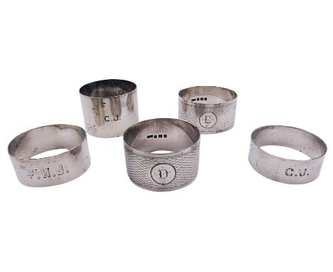 Five silver napkin rings, each of circular form, two examples with engine turned decoration, one Victorian example hallmarked