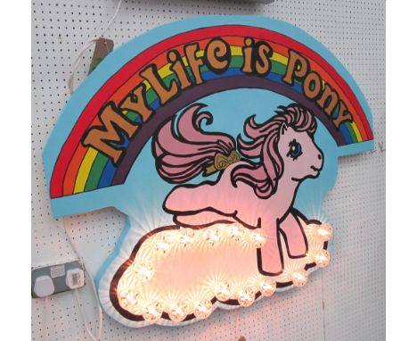 'MY LIFE IS PONY', bespoke signage by Bee Rich with graphic Pony Character on light up cloud and the slogan emblazoned across