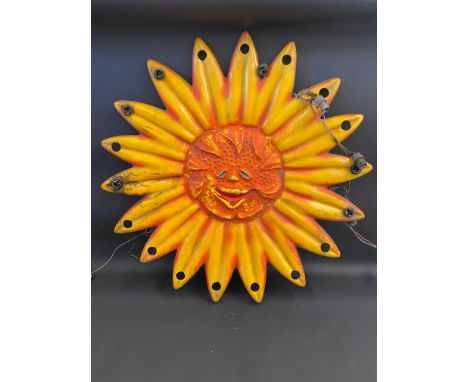 A circa 1960s fairground sun with holes for light fittings, from a juvenile ride.