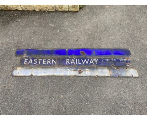 Three narrow railway enamel signs, one bearing the letters LNER, one plain blue and the third Eastern Railway, the largest 72