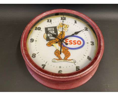 A reproduction garage battery operated wall clock, decorated to the dial with an Esso 'Tiger in your tank' logo, 12" diameter