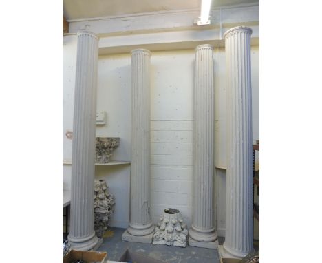 Four very tall classical columns with separate carved corinthian capitals, by repute made for the BBC's 'Up Pompei' series as