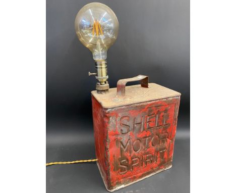 A Shell Motor Spirit two gallon petrol can, drilled through the side and through the cap to form a lamp.