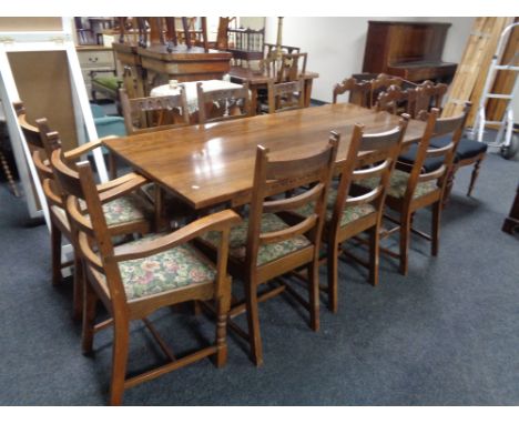 A good quality oak refectory dining table together with a set of eight ladder backed chairs (two carvers and six singles) CON