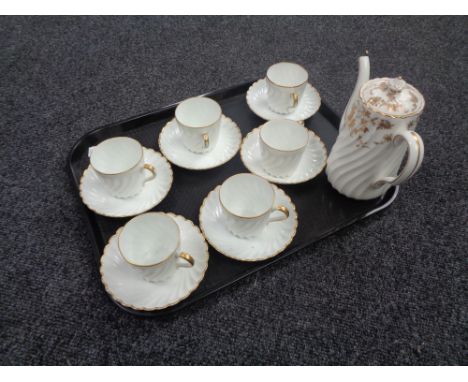 A tray containing a Minton's Ancestral white and gilt teapot together with six similar teacups and saucers. 