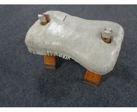 A camel stool with leather saddle 