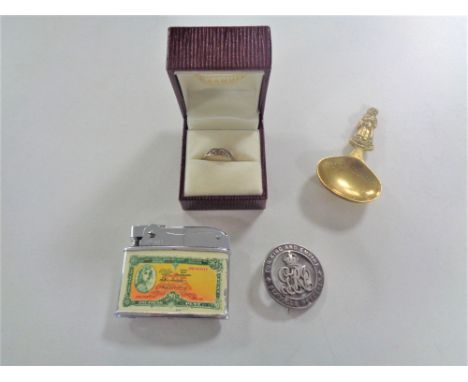 A brass caddy spoon together with Dragon lighter, military service badge.