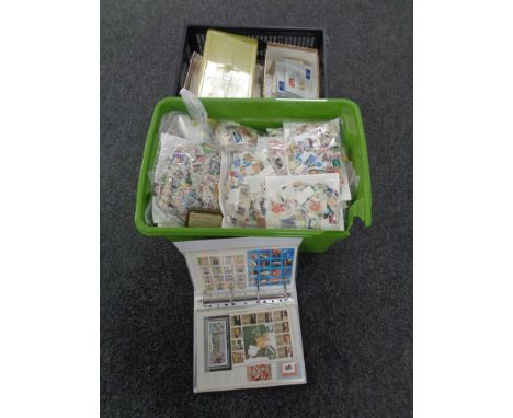 Two boxes containing a large quantity of loose world stamps, first day covers.   