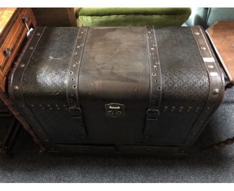 A faux leather dome topped trunk fitted two drawers 
