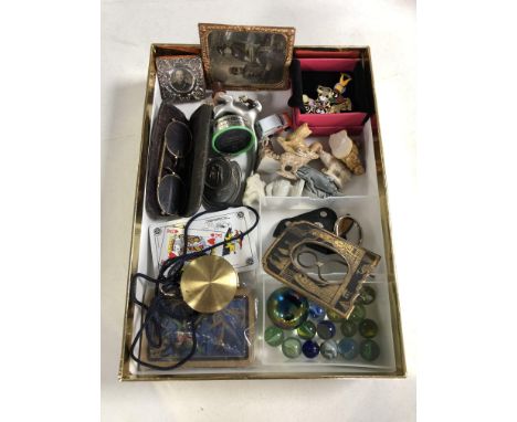A box containing miscellaneous items to include vintage gilt rimmed spectacles, marbles, playing cards, brass cased pocket co