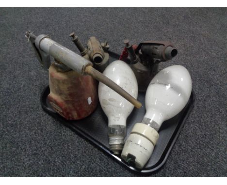 A tray of two vintage blow lamps, Esso U.C.L. oil can and two vintage light bulbs 