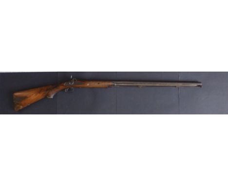 A 19thC long barreled percussion lock gun, the hexagonal barrel with ramrod, ammunition compartment to butt, 48" overall - a/