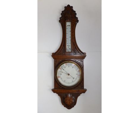 A carved oak banjo barometer/thermometer - W. Bruford &amp; Son, Eastbourne, 35".