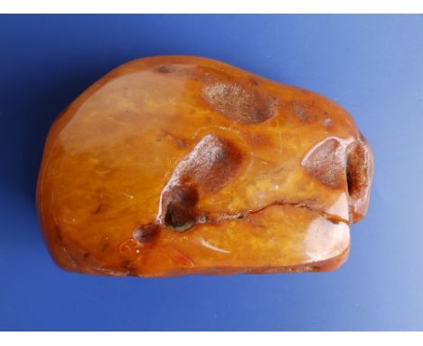 A large natural specimen of Baltic amber of butterscotch colour, accompanied by a Gem &amp; Pearl Lab Report stating the item