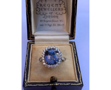 A certified natural colour change 9.58 carat Sri-Lankan sapphire &amp; diamond cluster ring, the claw set rectangular cushion