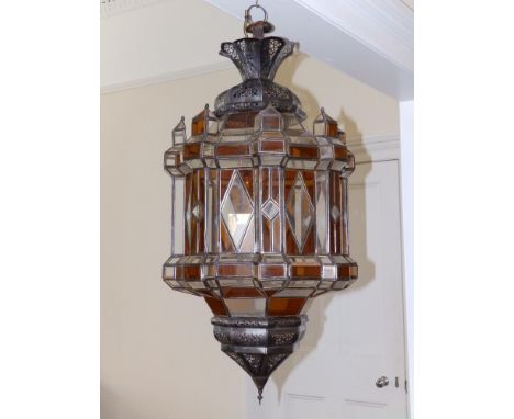 A large North African metal frame hanging lantern fitted with amber &amp; colourless glass panels, 34" high.
