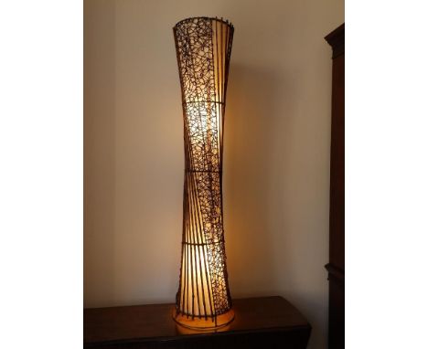 A canework &amp; fabric electric floor lamp, of slender waisted form, 59" high.