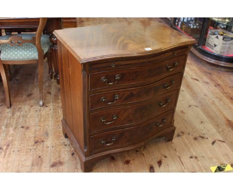 Mahogany serpentine front chest having brush slide above four long drawers on bracket feet, 77cm high by 71cm wide by 46cm de