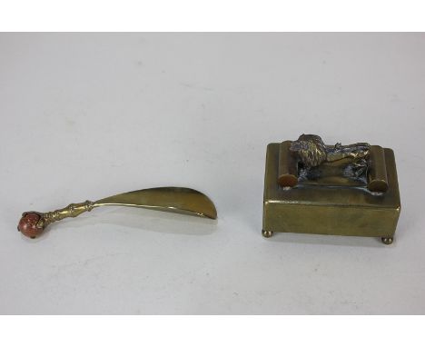 A French brass music box, mounted with a lion, marked Modele Depose No 144 (a/f), together with a brass shoe horn, the finial