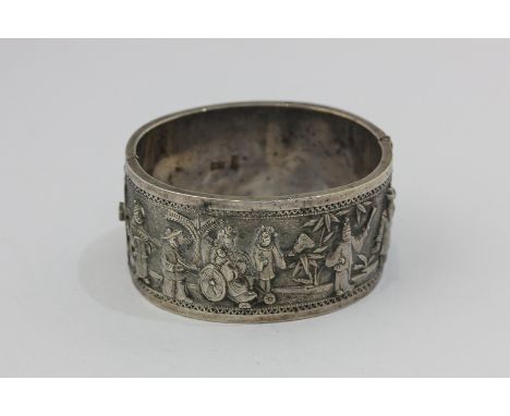 A Chinese export silver bangle, hollow hinged and chased with figures in various landscapes, maker's mark  of LW for Luen Wo