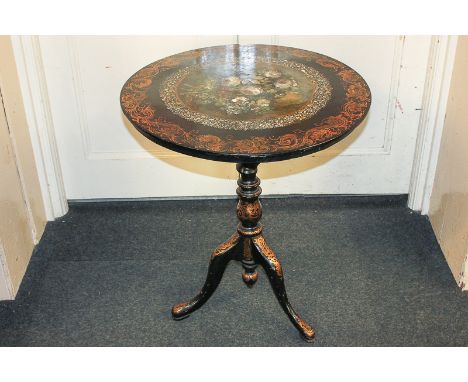 A Victorian papier mache circular tilt-top table with painted floral panel surrounded by mother of pearl and gilded decoratio