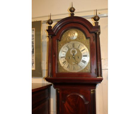 A George III mahogany longcase clock with 12 inch arched brass dial, with seconds dial and calendar aperture, silvered dial a