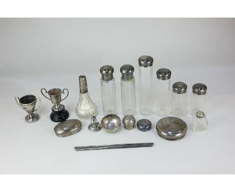 Eight silver mounted cut glass dressing table bottles, two EPNS trophy cups, a silver comb mount, silver lids, one stamped As