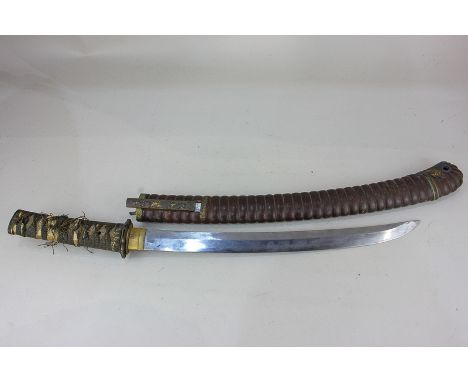 A Japanese short sword with 15 inch curved blade and fabric bound handle, in ribbed scabbard (a/f), 61cm