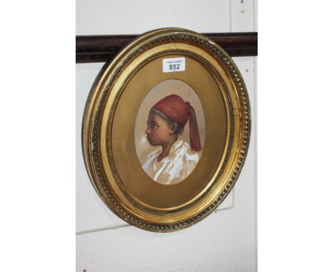 19th century school, oval mounted portrait of a young boy wearing a fez, oil, 17.5cm by 12cm