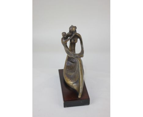 A bronze figure of a woman embracing a child, stylised flowing form, mounted on rectangular wooden base, 19cm high