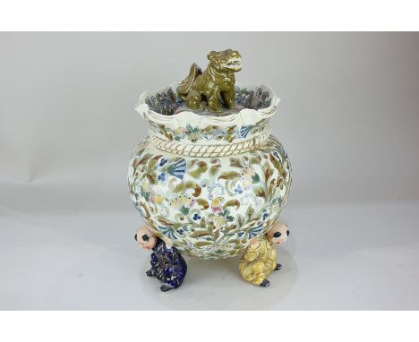 A Fischer Budapest novelty ceramic bowl and cover in the form of a sack supported by three Chinese character figures, with Do