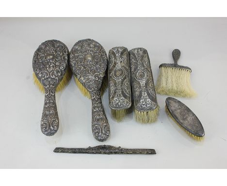 A pair of Victorian silver mounted hair brushes (a/f), a pair of silver mounted clothes brushes, a silver comb mount, and two