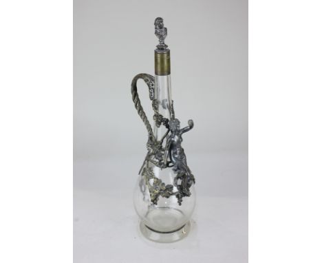 A WMF metal mounted glass decanter and stopper, teardrop form, decorated with a classical figure amongst grapes and vine leav