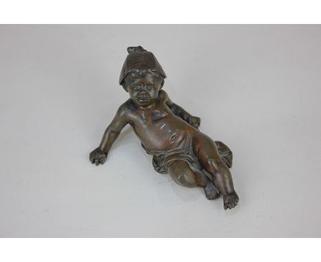 A 19th century bronze figure of a reclining child wearing a hat, the base impressed Lalouette, 5cm high