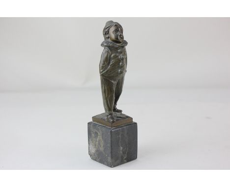 Herrmann, a small bronze figure of a child in clown costume standing on marble plinth, 14cm
