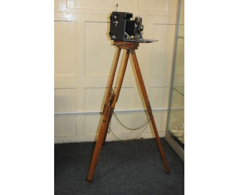 A Speed Graphic camera with Carl Zeiss lens, on wooden tripod stand