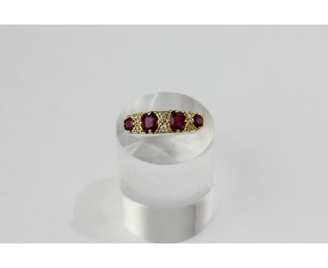 A ruby and diamond ring, claw set with four mixed cut rubies, with rose diamond points, in 18ct gold