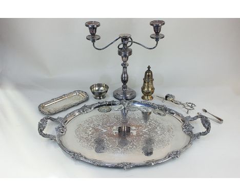 A large silver plated oval tea tray with two scroll handles, a three-sconce candelabra, a candle snuffer, five decanter label