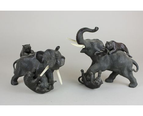 Two Japanese Meiji period bronze figure groups of two lions attacking a bull elephant, seal mark and character marks to base,