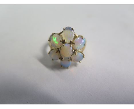 A 9ct yellow gold opal seven stone ring, size N, approx 4.5 grams, in good condition 