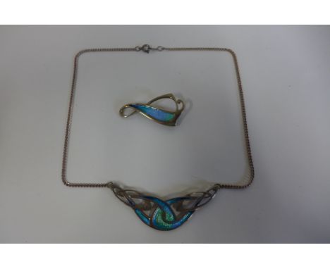 A silver and enamel decorated pendant on silver necklace and similar brooch, approx 0.5 troy oz, overall in good condition, s