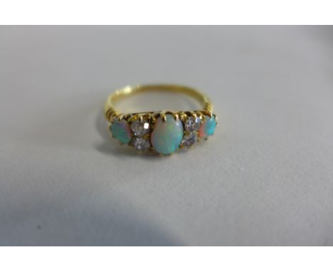 A yellow gold opal and diamond ring, tests to approx 18ct, ring size N, approx 3.2 grams, opals bright, generally good condit