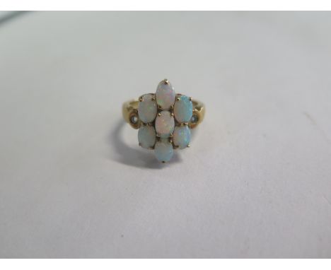 A 9ct yellow gold opal seven stone ring, size N, approx 4.2 grams, in good condition 