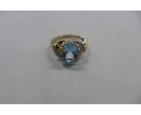 A 9ct gold aquamarine and diamond ring, size K, approx 3 grams, in good condition, some usage marks 