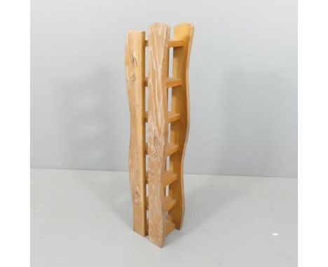 A limed oak 7-tier shelf, with applied musical note decoration. 20x100x17cm. 